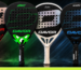 Five Davor padel rackets from the PRO range by Iciar Montes displayed against a dramatic red, green and blue lit background: Beacon, Legacy (green), Elite, Icon and Legacy (orange), each with a large hole-patterned face and the Davor logo