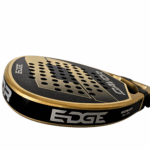 Close-up view of the Edge Davor padel racket face showing the metallic gold finish, black background, and drilled hole pattern forming part of the bold “D” graphic.